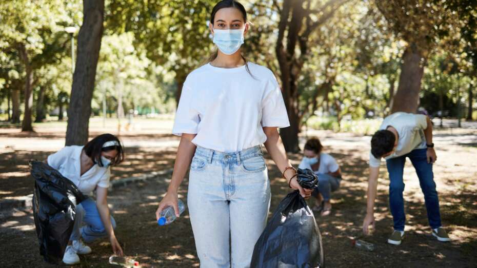 Covid, face mask and volunteer worker cleaning park, doing community service and helping pick up tr