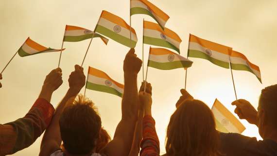 People holding small indian flags.